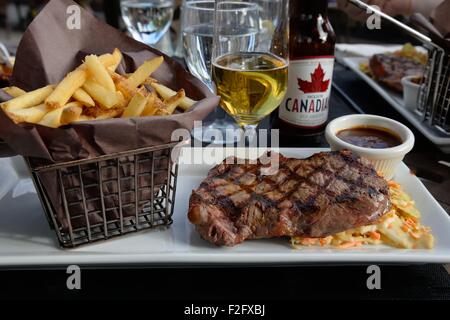 Barbecued Alberta rib-eye steak, salad and chips in a basket at the Fairmont Jasper park lodge, Canada. Stock Photo