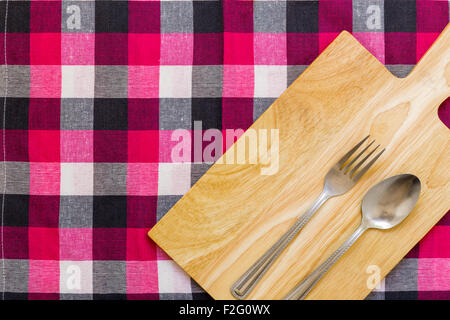 Empty plate with spoon and fork on table background. Stock Photo