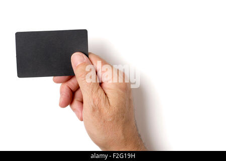 Close up of man's hand holding blank black card. Studio shot isolated on white. Stock Photo
