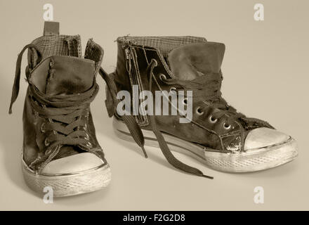 pair of rundown sneakers in warm toned ambiance Stock Photo