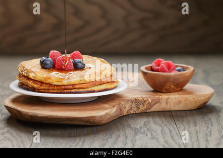 Pancakes with raspberry, blueberry and maple syrup Stock Photo