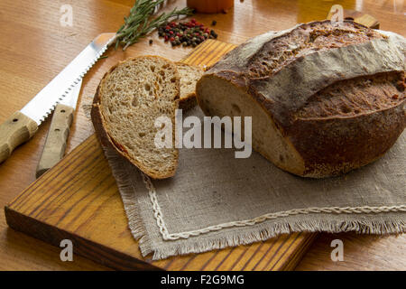 Fresh Tradition bread laying on the old Wooden cutting board Stock Photo