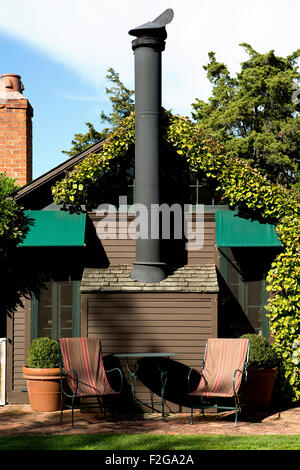Large stone chimney on the outside of a two-story house Stock Photo - Alamy