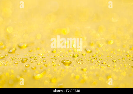 blurred water drops on yellow background Stock Photo