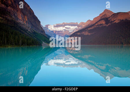 Glacial Lake Louise with Victoria glacier and mountains reflected in emerald water, Banff National Park, Alberta, Canada Stock Photo
