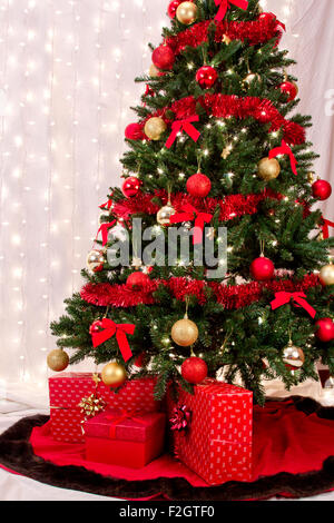 Decorated Christmas tree with presents under it. Stock Photo