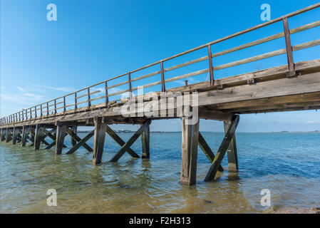 Old weathered wooden jetty on the seafront Stock Photo
