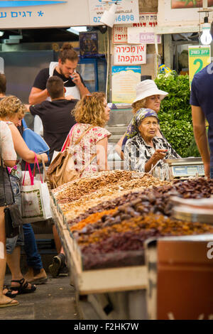 Jerusalem,Israel - JULY 30, 2015:A stall holder serves customers at the Jerusalem Market in Jerusalem,Israel  on JULY 30, 2015. Stock Photo