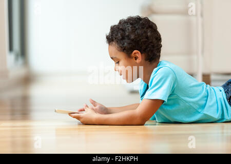 African american little boy using a tactile tablet Stock Photo