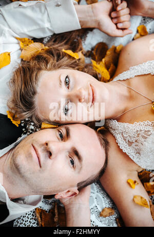 wedding couple lying under a tree Stock Photo