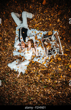 wedding couple lying under a tree Stock Photo
