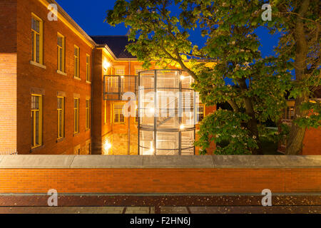 A tree partially obscures the Liberal Arts & Science Building 'K Building' at the Humber College Lakeshore Campus at dusk. Stock Photo