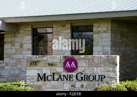 A logo sign outside of the headquarters of the McLane Company in Temple