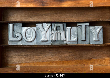 loyalty word made from metallic letterpress type on wooden tray Stock Photo