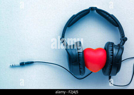 black headphones with red heart toned in blue Stock Photo