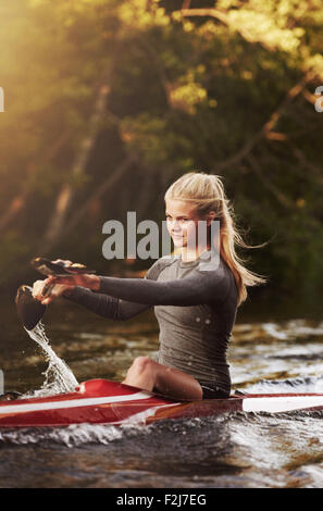 Athletic elite kayaker racing on the water Stock Photo