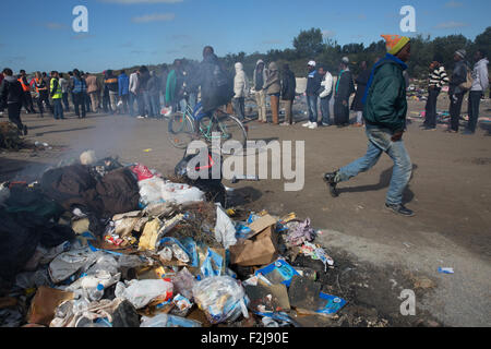 Calais, France. 19th September, 2015. Refugees at ‘the Jungle’ camp in Calais queue to receive aid Credit:  On Sight Photographic/Alamy Live News Stock Photo
