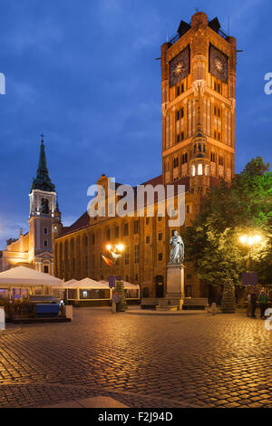 Old City Town Hall (Polish: Ratusz Staromiejski) on Market Square in Torun, Poland at night, Gothic architecture dating back to Stock Photo