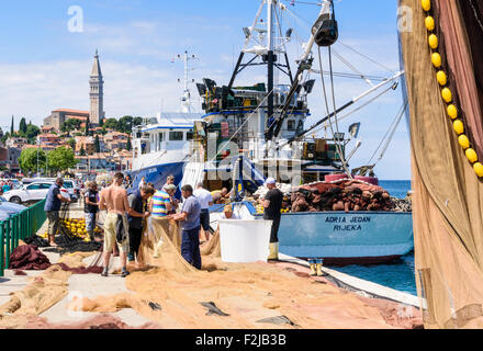 Fishermen tending to their fishing nets in Rovinj, Croatia Stock Photo