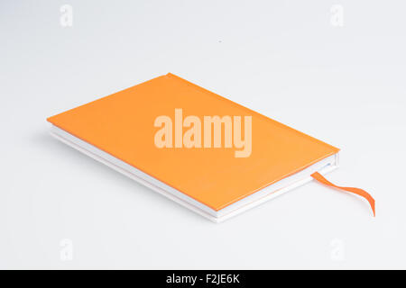 Orange note book on white background Stock Photo