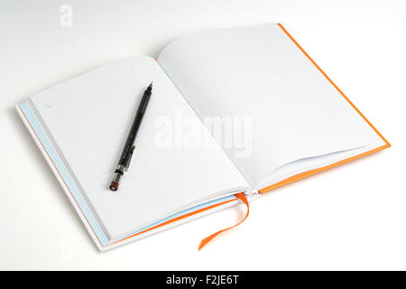 Open a blank white notebook and pen on white background Stock Photo