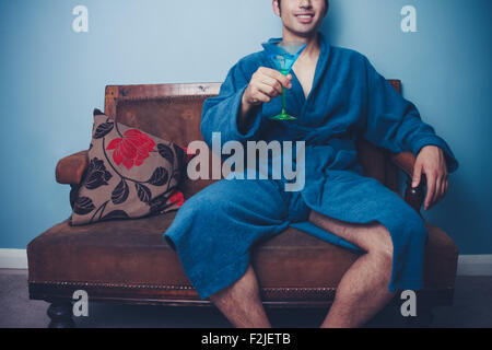 Man in bathrobe with cocktail Stock Photo