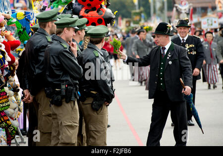 Munich, Germany. 20th Sep, 2015. Police officers watch the traditional costumes and marksmen's parade at the 182nd Oktoberfest in Munich, Germany, 20 September 2015. The world's largest beer festival which will run until 04 October 2015 is expected to attract some six million visitors from all over the world this year. Photo: SVEN HOPPE/dpa/Alamy Live News Stock Photo