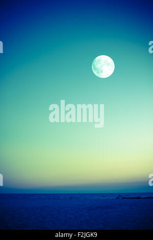 Beautiful full moon over ocean Stock Photo