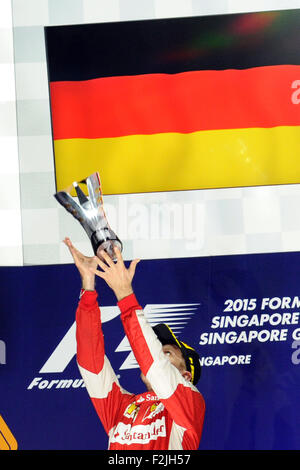 Singapore. 20th Sep, 2015. Team Ferrari driver Sebastian Vettel celebrates his victory on the podium during the 2015 F1 Singapore Grand Prix (GP) Night Race at the Singapore's F1 Pit Building, on Sept. 20, 2015. Sebastian Vettel won the F1 Singapore GP Night Race held on Singapore's Marina Bay Street Circuit. Credit:  Then Chih Wey/Xinhua/Alamy Live News Stock Photo