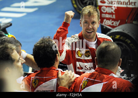 Singapore. 20th Sep, 2015. Team Ferrari driver Sebastian Vettel celebrates his victory in the 2015 F1 Singapore Grand Prix (GP) Night Race at the Singapore's F1 Pit Building, on Sept. 20, 2015. Sebastian Vettel won the F1 Singapore GP Night Race held on Singapore's Marina Bay Street Circuit. Credit:  Then Chih Wey/Xinhua/Alamy Live News Stock Photo