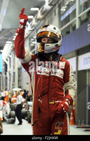 Singapore. 20th Sep, 2015. Team Ferrari driver Sebastian Vettel celebrates his victory in the 2015 F1 Singapore Grand Prix (GP) Night Race at the Singapore's F1 Pit Building, on Sept. 20, 2015. Sebastian Vettel won the F1 Singapore GP Night Race held on Singapore's Marina Bay Street Circuit. Credit:  Then Chih Wey/Xinhua/Alamy Live News Stock Photo