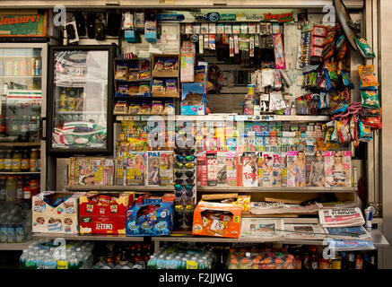 A cluttered Manhattan newsstand selling newspapers, magazines, snacks, sodas, sunglasses and cigarettes;  New York City Stock Photo