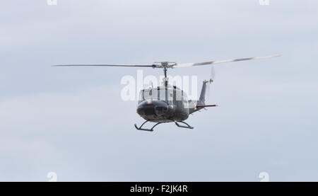 Yeovilton, UK - 11th July 2015: Vintage Bell 'Huey' helicopter flying at Yeovilton Air Day. Stock Photo