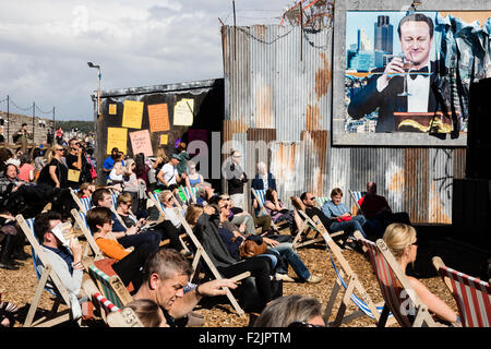 Billboard showing a smug David Cameron UK prime minister dominates the filmshow audience at Banksy's Dismaland in Weston s Mare Stock Photo