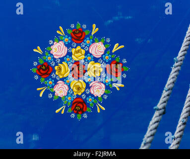 Traditional narrowboat art of hand painted roses and forget me nots on an English canal barge UK Stock Photo