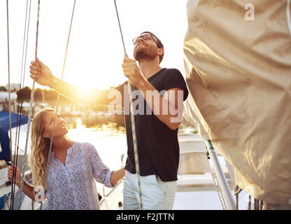 Couple on Their Sail Boat Checking it Before heading out Stock Photo