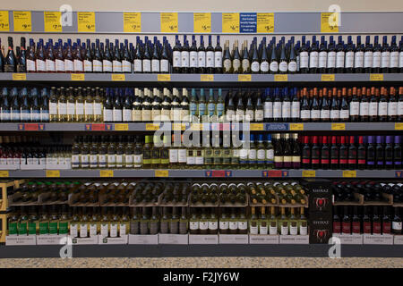 Bottles of red and white wine on sale in a supermarket. Stock Photo