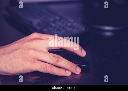 man's hand on computer mouse Stock Photo