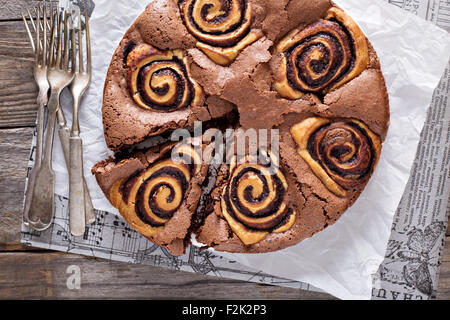 Chocolate cake with sweet chocolate cinnamon rolls inside Stock Photo