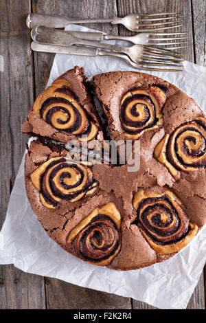 Chocolate cake with sweet chocolate cinnamon rolls inside Stock Photo