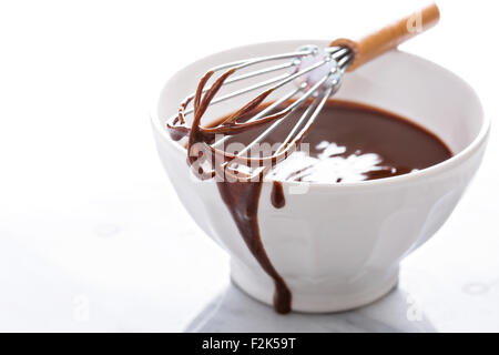 Melted chocolate in a bowl with a whisk Stock Photo