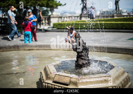 Fuente del Chapulín Grasshopper Fountain Mexico City / MEXICO CITY, Mexico — Water sprays around the bronze Fuente del Chapulín (Grasshopper Fountain) centered within an octagonal stone basin on the south terrace of Chapultepec Castle. Created by sculptor Luis Albarrán y Pliego, the piece was installed in 1924 during the presidency of Álvaro Obregón. The insect directly references the site's indigenous Nahuatl name, Chapultepec, which translates to "Grasshopper Hill." This open-air courtyard is part of the upper residential level of the historic 1785 complex, which currently serves as Mexico's Stock Photo