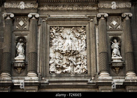 The southern facade of the Metropolitan Tabernacle features ornate depictions of the Eucharist with images of the Apostles, Church Fathers, saints who founded religious orders, martyrs as well as scenes from the Bible. Adjacent to the Metropolitan Catheral, facing the Zocalo, the Metropolitan Tabernacle (Spanish: Sagrario Metropolitana) was built by Lorenzo Rodríguez in the Baroque style between 1749 and 1760. It was designed to to house the archives and vestments of the archbishop. It also functioned and continues to function as a place to receive Eucharist and register parishioners. Stock Photo