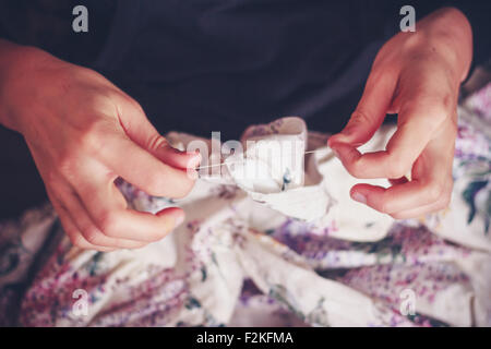 Hands of young woman sewing Stock Photo