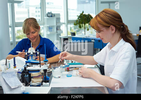 Two dental technicians working in a dental laboratory Stock Photo