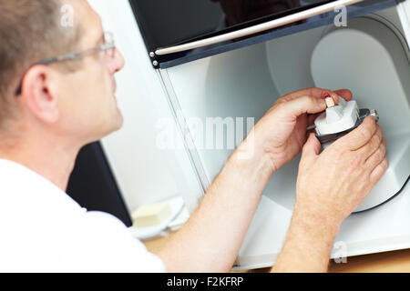 Dental technician placing a dental model in a 3D scanner Stock Photo