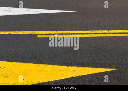 Directional arrows on asphalt road. Selective focus Stock Photo