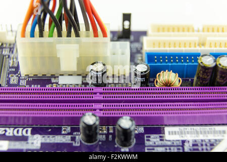 Cables connected to a DDR slots on computer motherboard, close-up Stock Photo