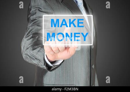 Businessman pushing virtual make money button on black background Stock Photo