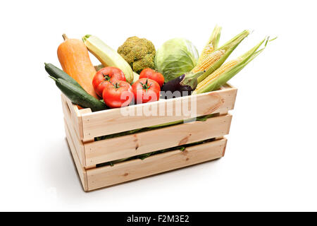Studio shot of a wooden crate full of different types of fresh vegetables isolated on white background Stock Photo